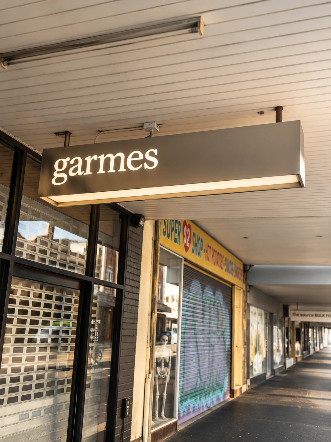 Garmes illuminated projecting lightbox beneath a shopfront awning